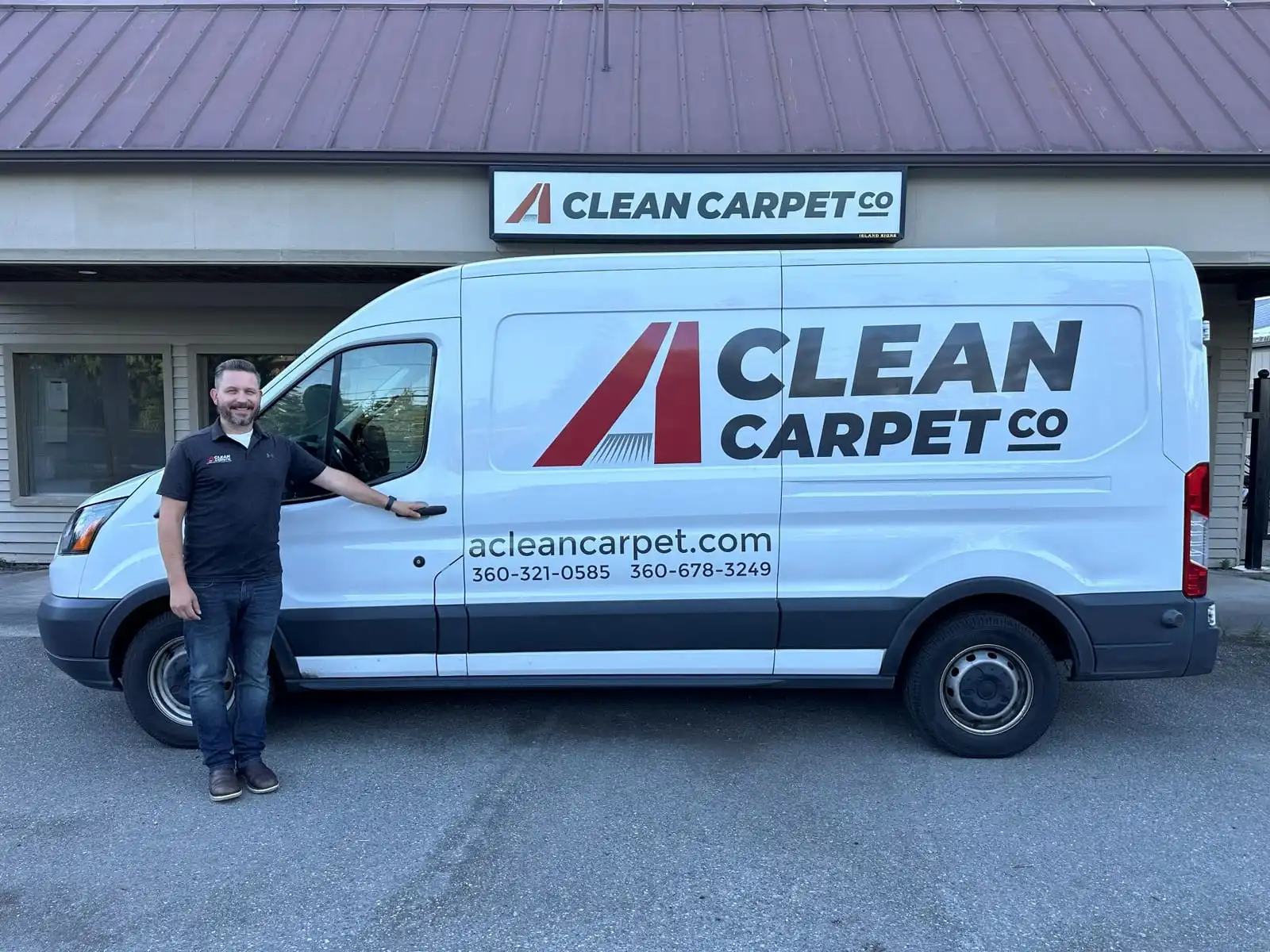 Caleb Cate, owner of A Clean Carpet Co, standing beside the company van outside the Freeland shop